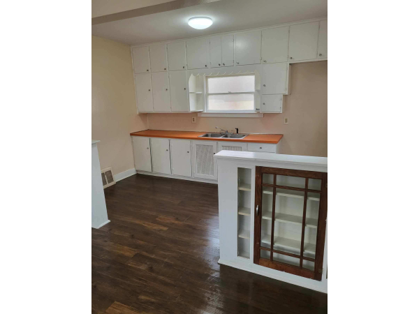 Large Kitchen with beautiful laminate floor and adjacent large diningroom